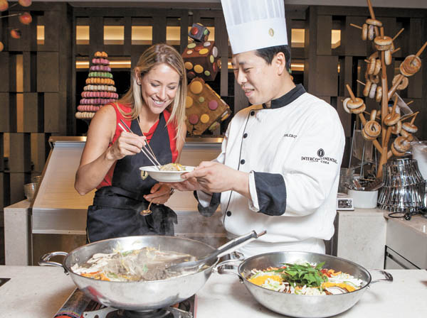 Chef Jeon Eun-chong offers Herrera finished bulgogi. 
