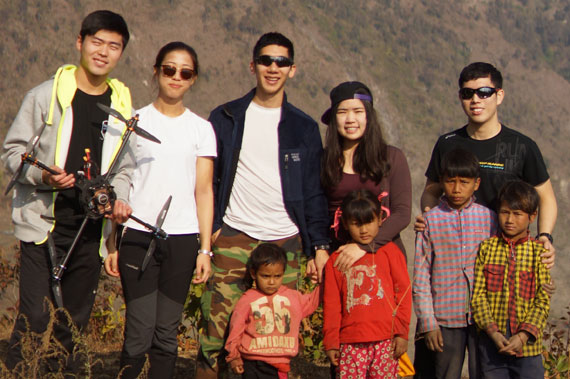 The members of Angel Swing, right, pose with the children from Narjamandap, a village in central Nepal. The drone the start-up team built, pictured above, delivered a box of medicine to residents in the remote area on Jan. 9, several months after the country was rocked by a 7.8-magnitude earthquake that killed thousands. [ANGEL SWING]