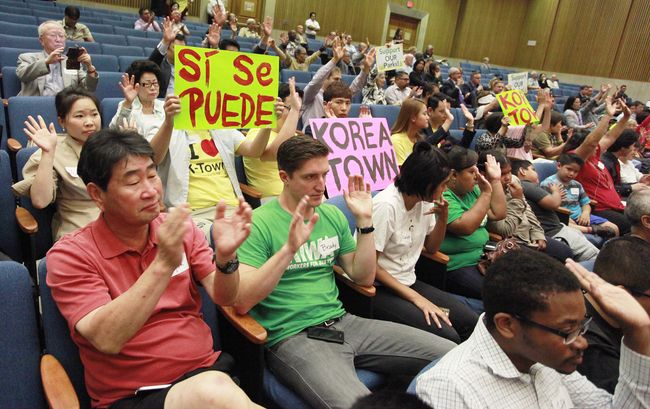 Koreatown residents holding a sign in support of building a community center on Vermont Avenue between 4th and 6th Streets at the L.A. County Board of Supervisor meeting on Tuesday. Sang Jin Kim 