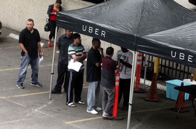 As the earnings of Uber and Lyft drivers have been revealed to be similar to those who receive the minimum wage, many of them are choosing an alternate employment. Picture above shows Uber drivers during their car inspections before work inside of a parking lot in L.A. Koreatown 