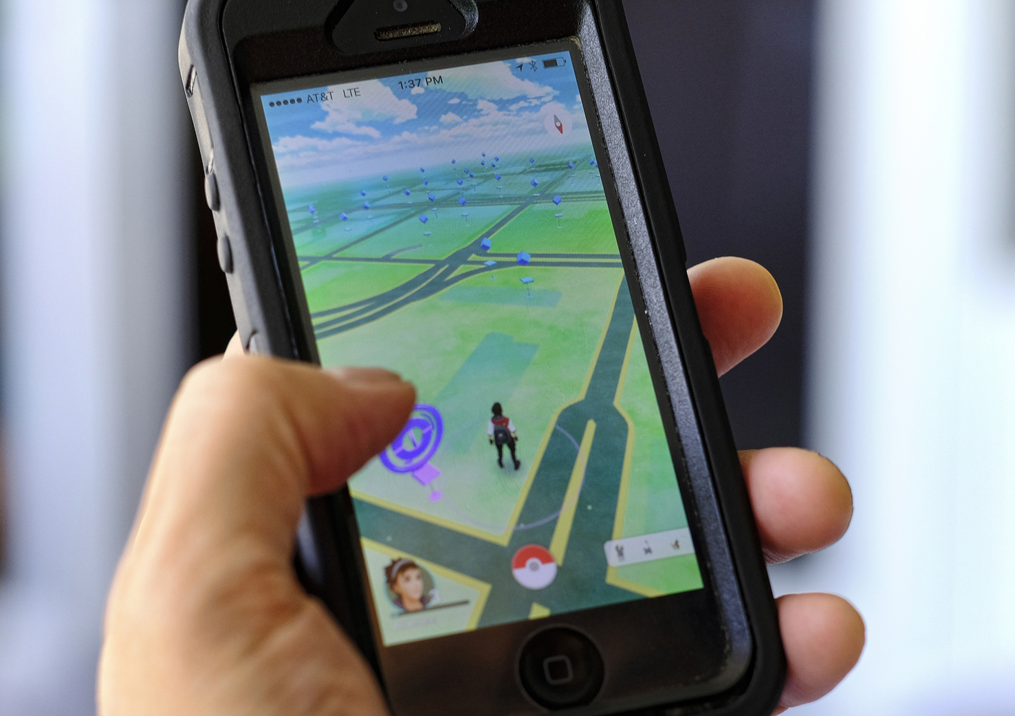 Pokemon Go is displayed on a cell phone in Los Angeles on Friday, July 8, 2016. Just days after being made available in the U.S., the mobile game Pokemon Go has jumped to become the top-grossing app in the App Store. And players have reported wiping out in a variety of ways as they wander the real world, eyes glued to their smartphone screens, in search of digital monsters. (AP Photo/Richard Vogel)