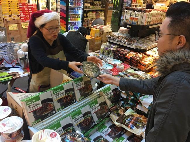 “Cup rice” is growing in popularity. A customer at Zion Market is looking at new cup rice items recently released by CJ Bibigo.