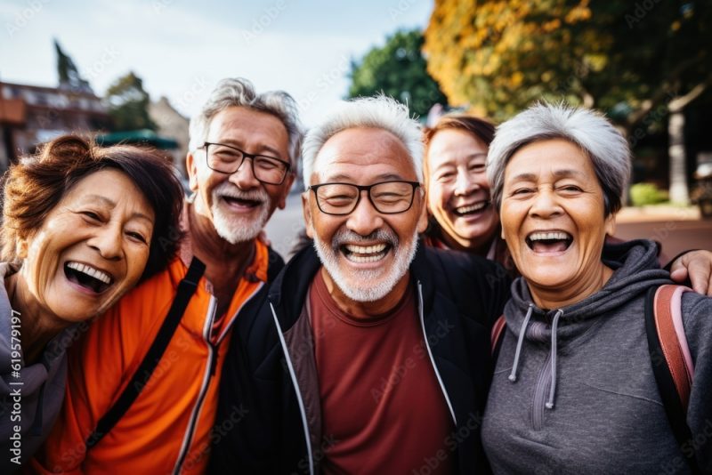 group of laughing happy old senior asian citizens looking at the camera