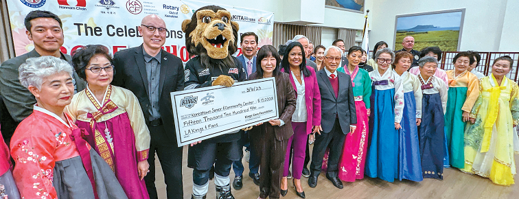 LA Kings staff and Korean American seniors pose with donation check after viral harmonica performance at senior center event