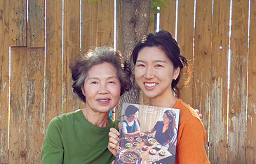 Sarah Ahn and Ahn Nam-Soon hold Korean food cookbook featured in Trader Joe’s kimbap article