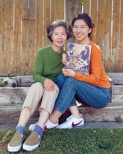 Sara Ahn and Ahn Nam-Soon hold Korean food cookbook featured in Trader Joe’s kimbap article