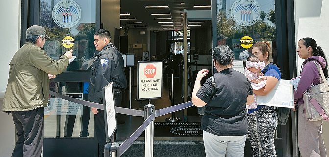 People wait in line outside the Social Security office in Koreatown, Los Angeles, highlighting service backlogs amid staff cuts.