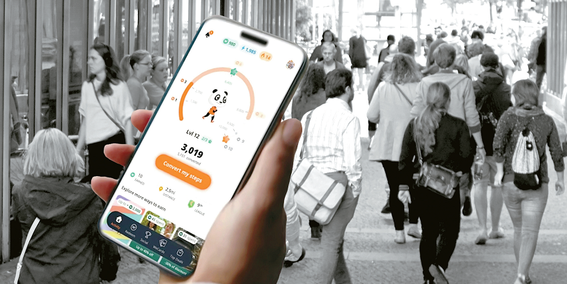 person holding screen of WeWard App, where you can walk to earn