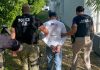 DHS Says Over 10,000 Undocumented Immigrants Arrested in LA Since June ICE agents detain a person during a deportation warrant crackdown