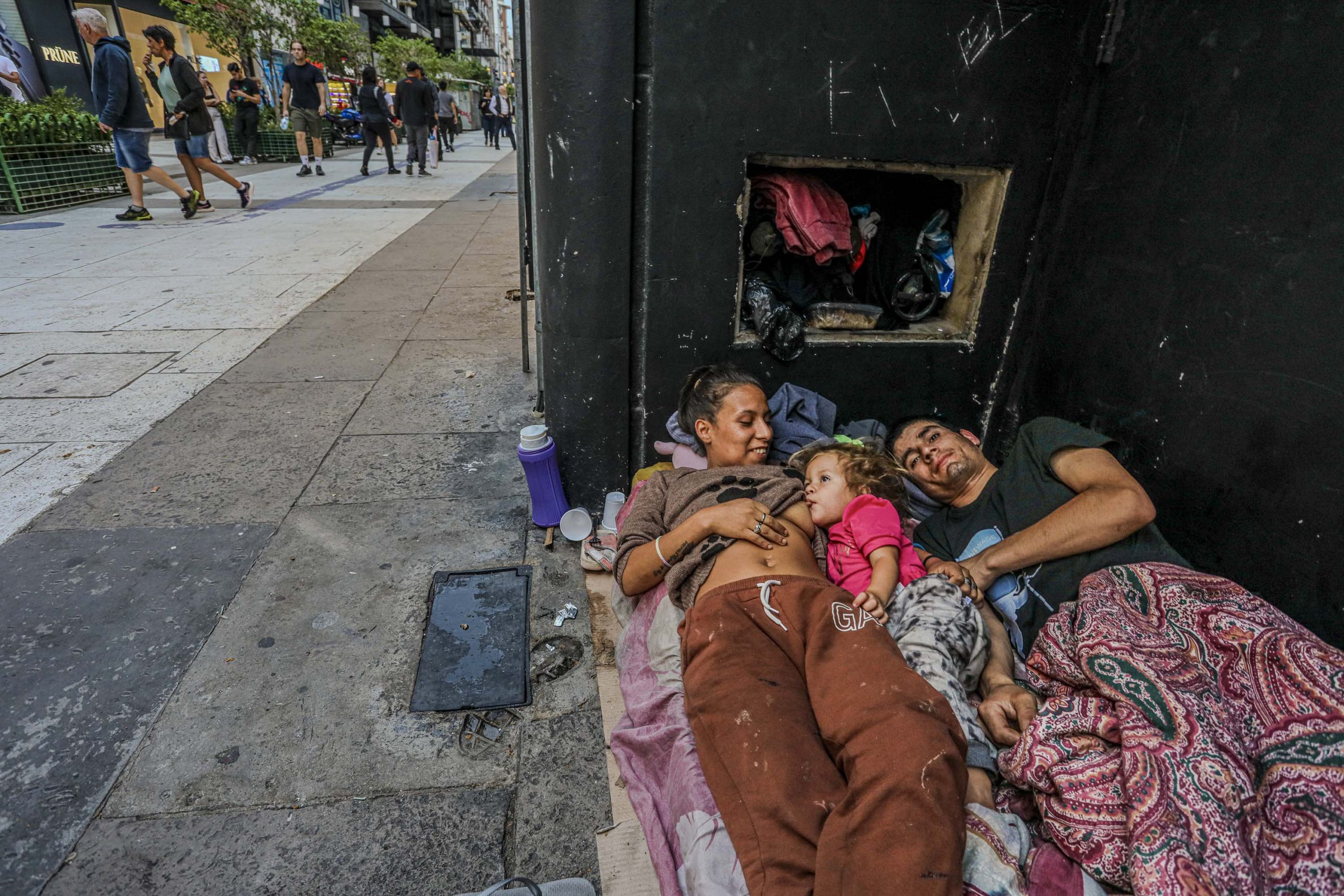 Argentina economic decline shown by homeless family Florida Street Buenos Aires
