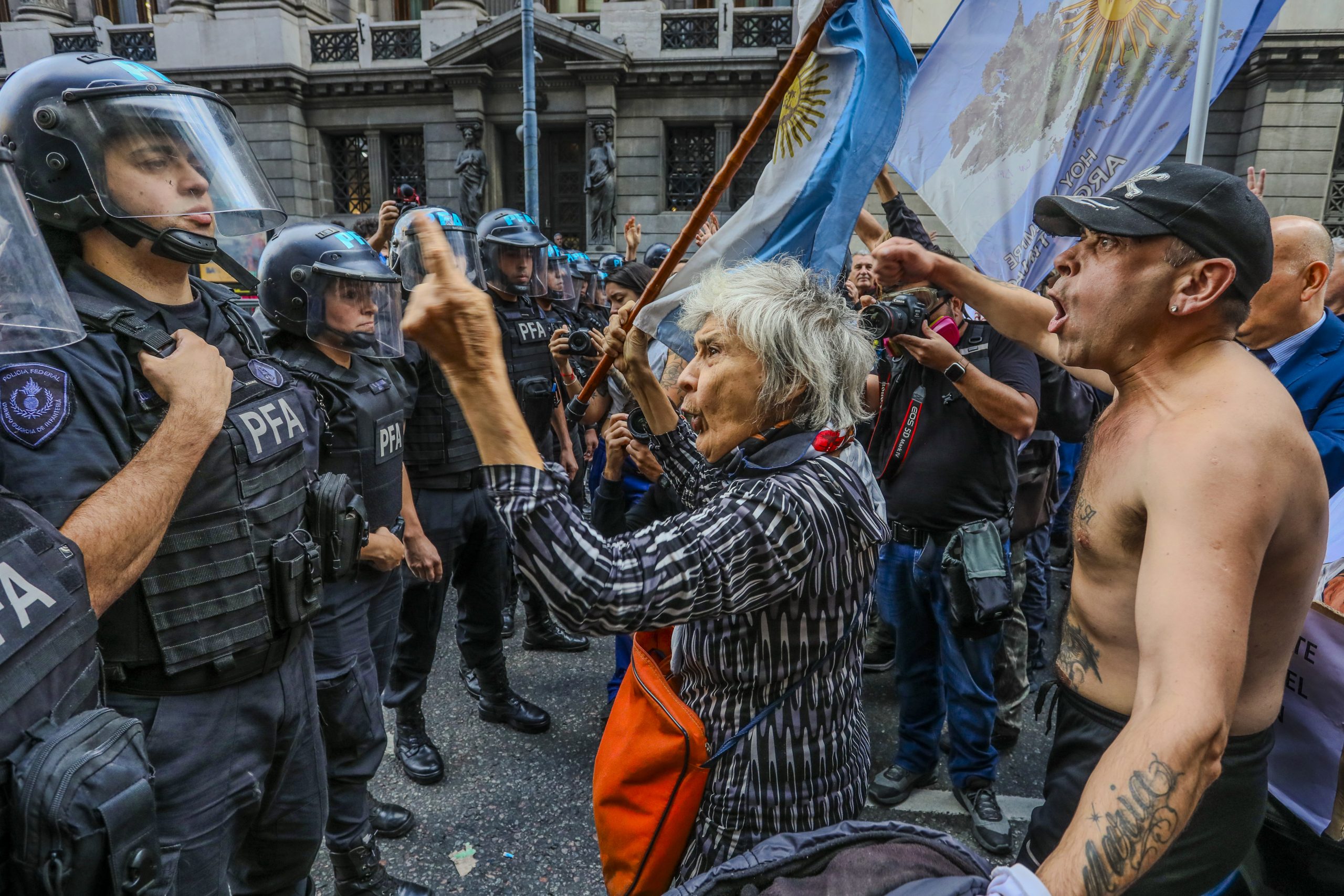 Elderly woman confronts riot police during Peronist nostalgia Argentina protest in Buenos Aires