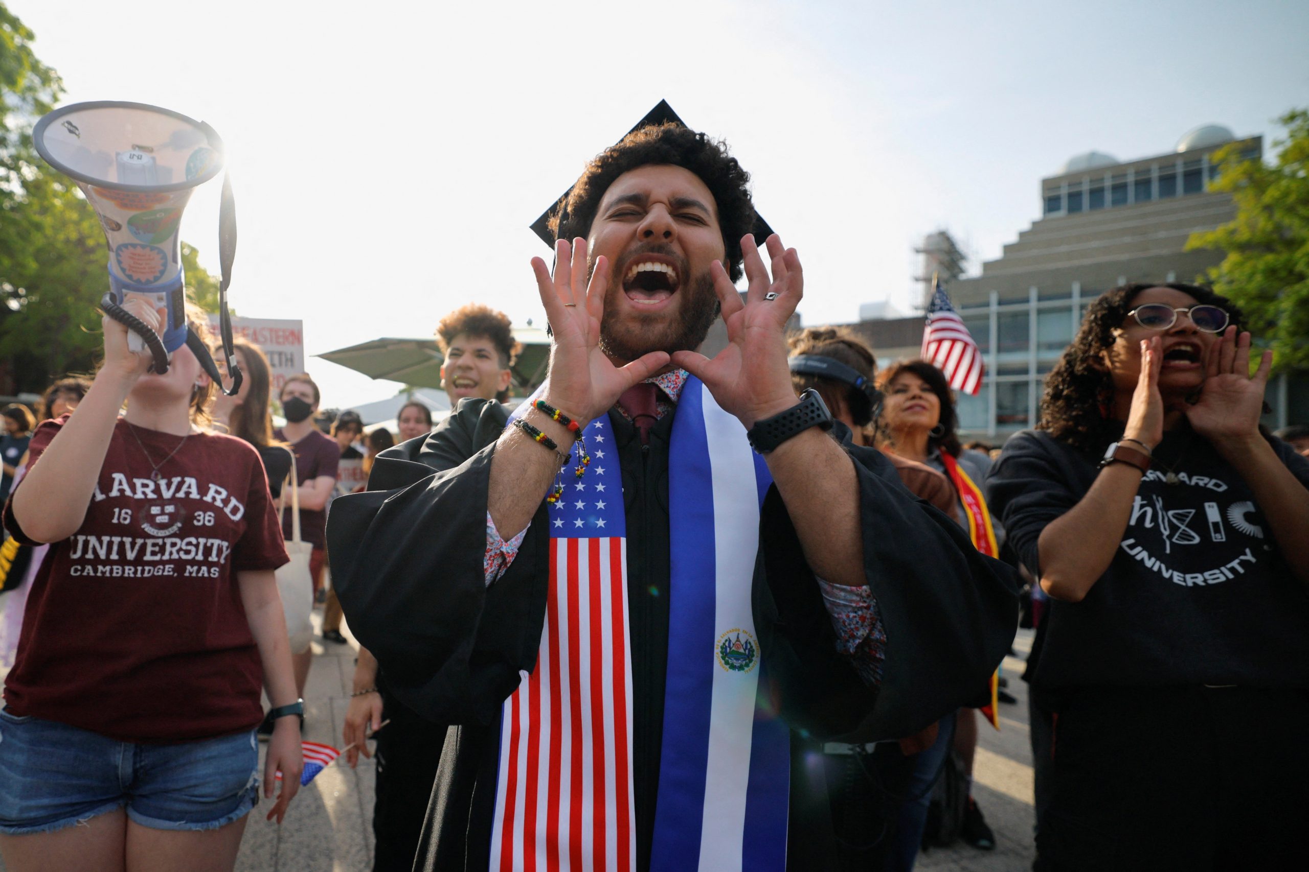 Student wears U.S. and El Salvador flag stole at Harvard rally for international students