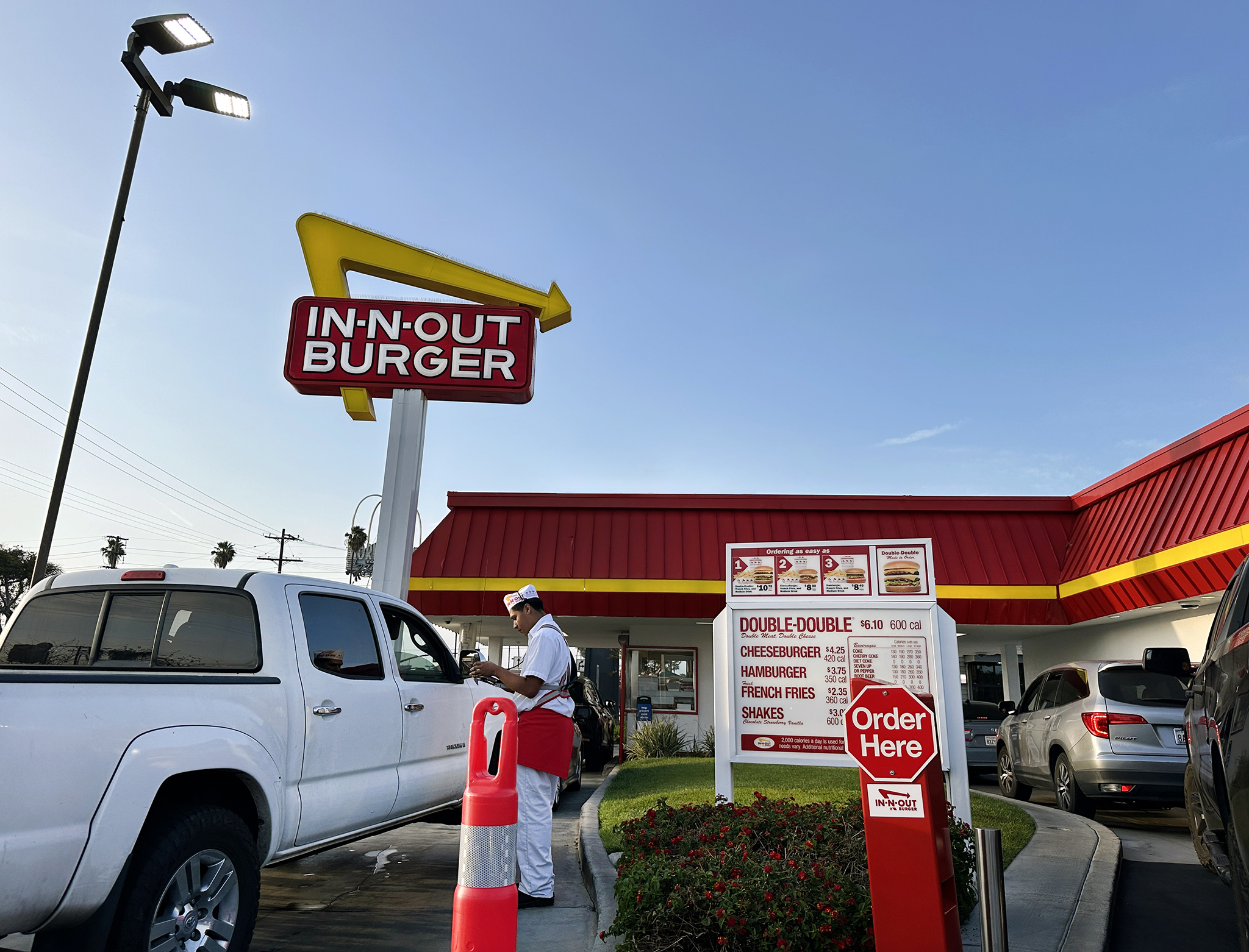 In-N-Out employee takes a drive-thru order at the Santa Ana location, named top U.S. burger chain by Yelp