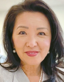 Suzette Rhee Nedrich, Korean American public information officer, smiling in a casual headshot