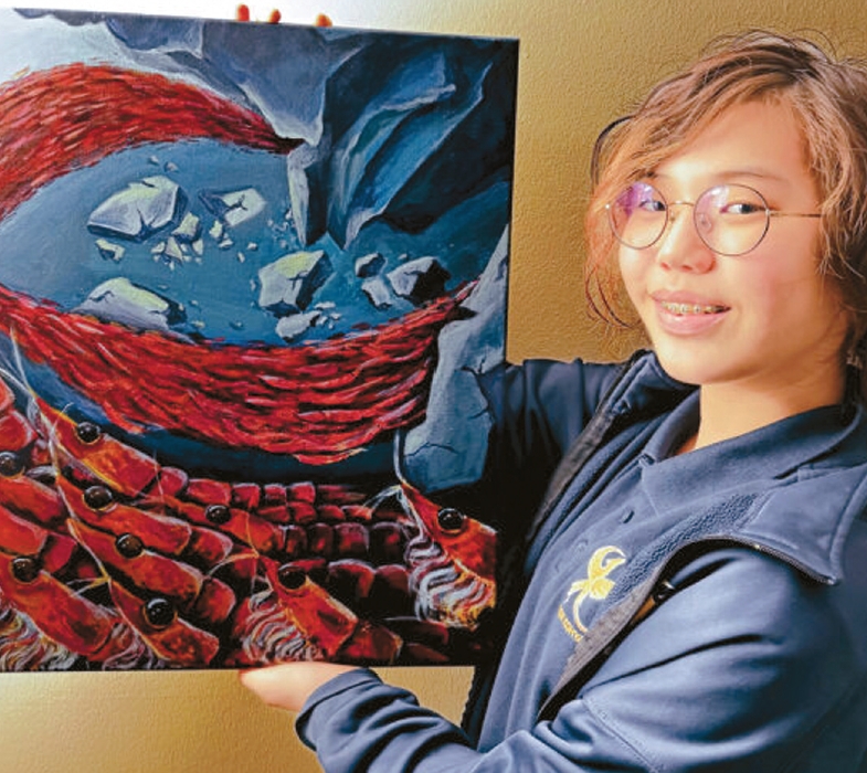 Jia Kim stands next to her krill-themed painting that won first place in an international art contest