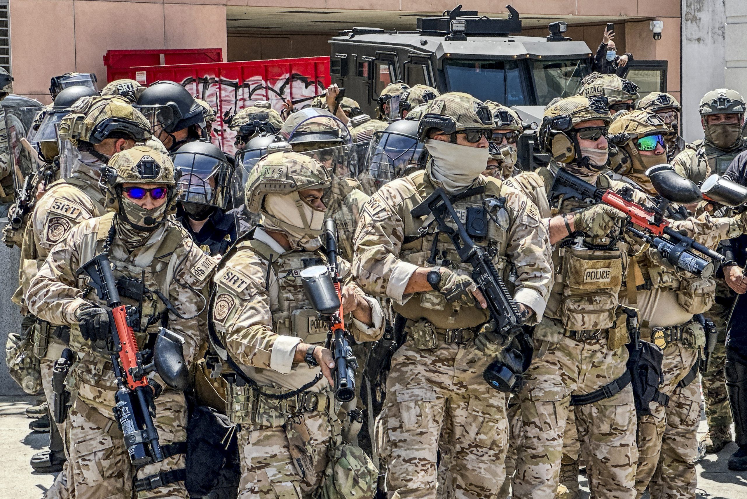 National Guard officers move in formation toward protesters near the Edward R. Roybal Federal Building during the Los Angeles curfew immigration protests