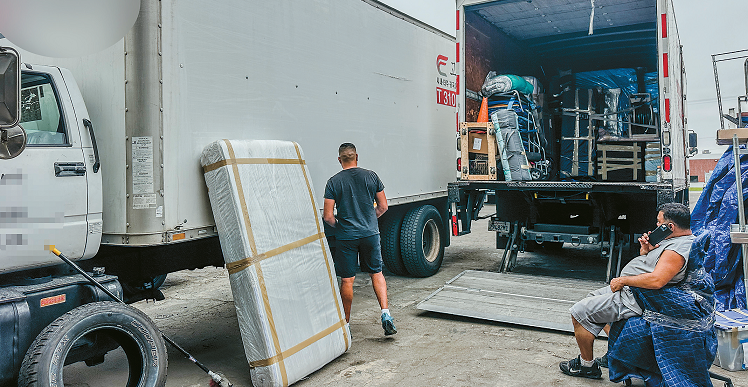 Truck drivers resting in a Gardena parking lot amid declining freight volume from U.S. tariff impact