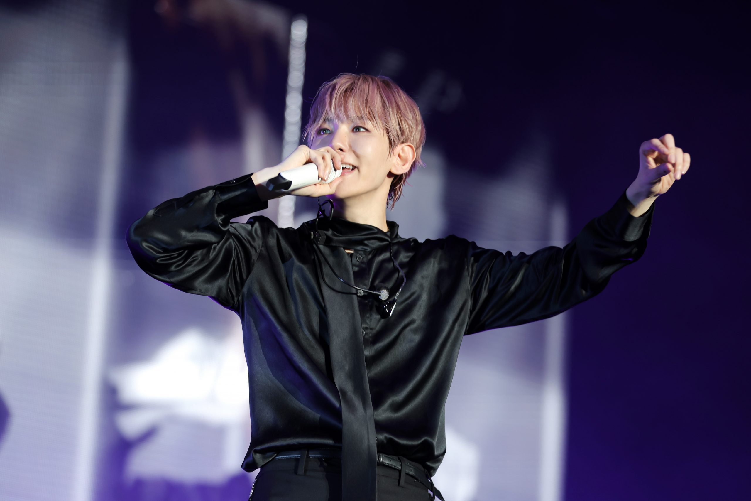 Baekhyun singing during his Reverie world tour concert at Kia Forum in Los Angeles