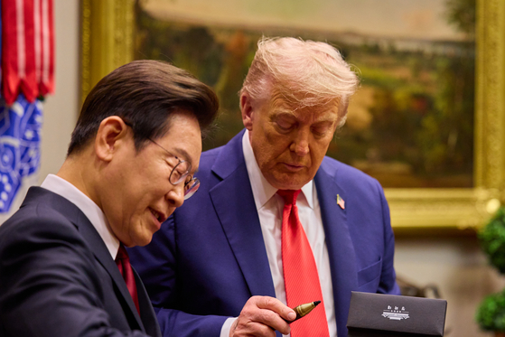 President Trump is gifted with a pen from Korean President Lee.