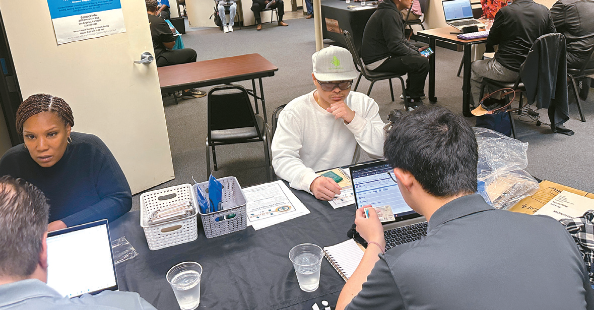 Residents meet with legal experts at the AADAP headquarters to discuss the expungement process during a free immigrant expungement clinic on the 7th.