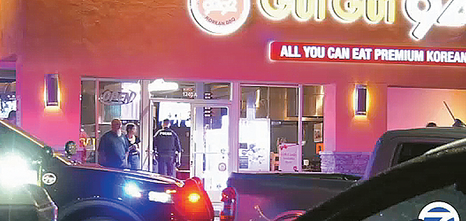 Police investigators examine the scene outside a Korean BBQ restaurant in La Habra after a murder-suicide on October 14, 2025.