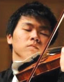 Korean American violinist John Shin performs on stage, symbolizing his return to music after his deportation case ended.