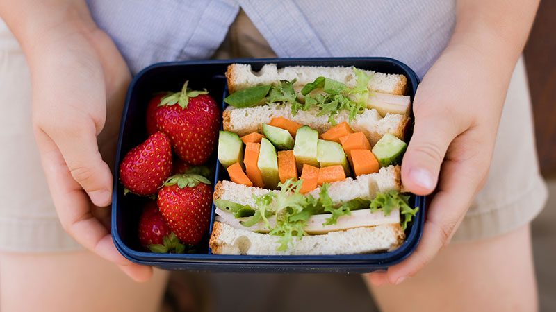 Packed lunch with healthy food in reusable containers on an office desk during lunchflation in LA