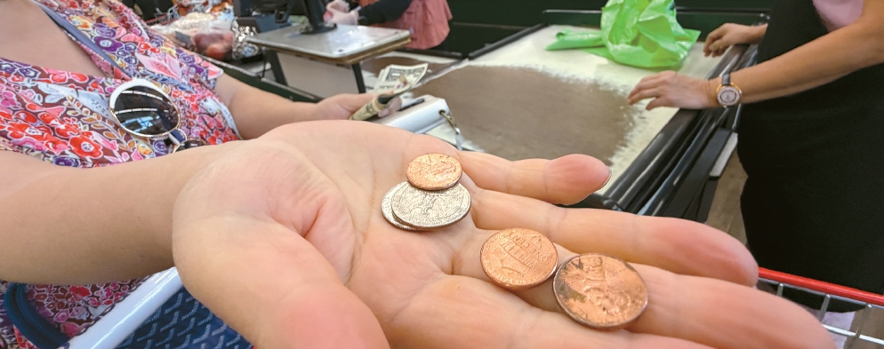 Customer counts penny change at a Koreatown Los Angeles market amid U.S. penny shortage
