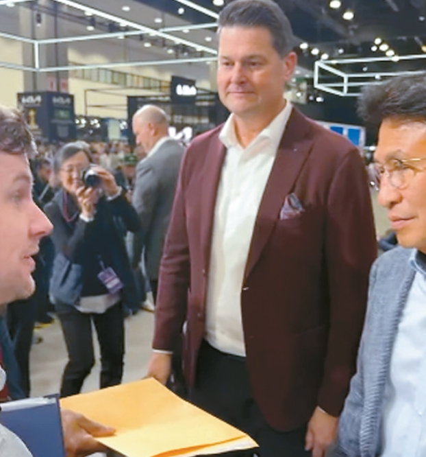 JMA representative delivering labor violation documents to Kia America leadership during Hyundai Kia labor violations protest