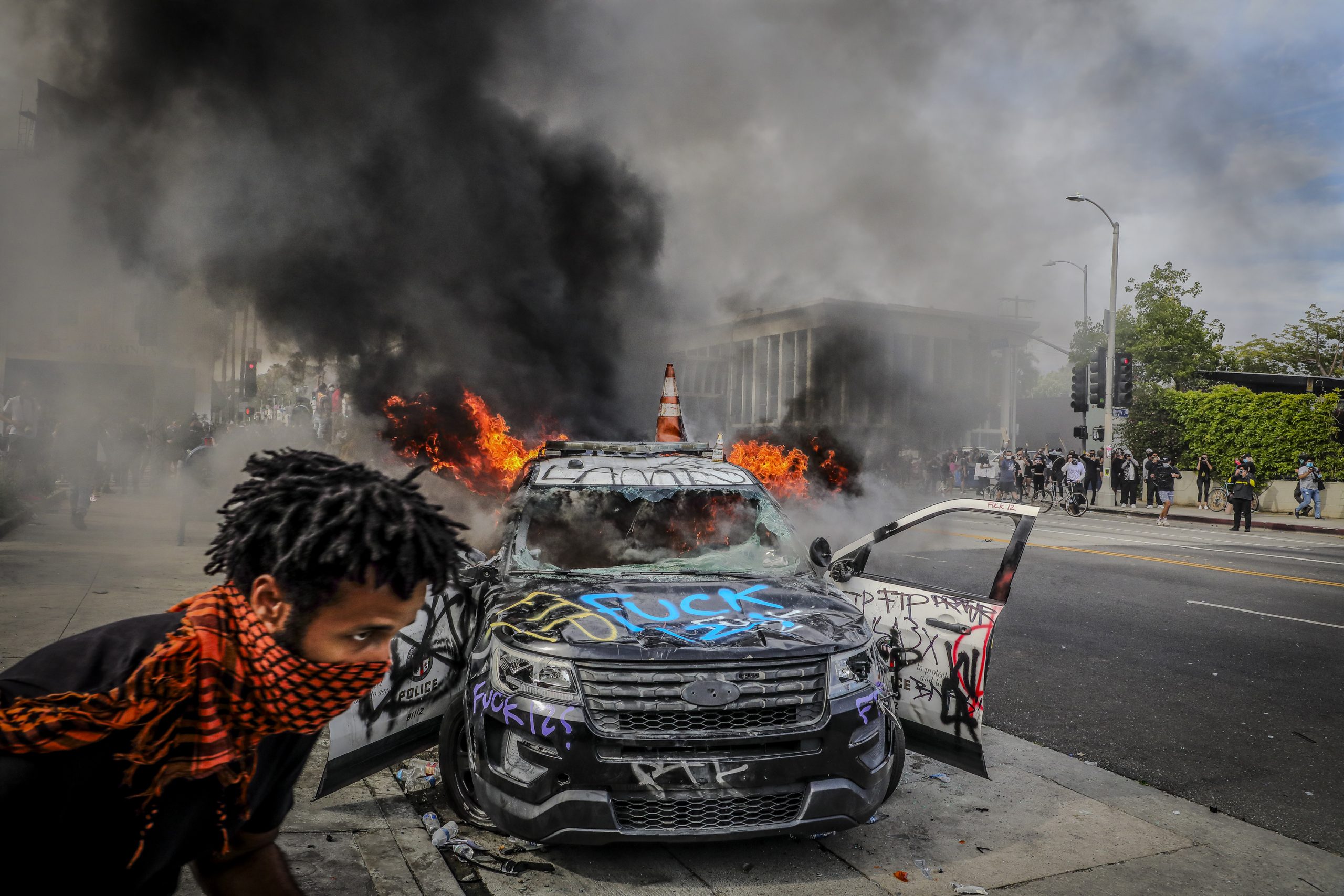 LAPD patrol car burns with graffiti during the May 30, 2020 BLM protest in Los Angeles, part of the BLM donation fraud investigation coverage.