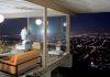 One of LA’s Most Famous Homes Just Hit the Market for $25 Million Stahl House for sale with nighttime view overlooking the Los Angeles city lights