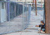 As Temperatures Drop, LA Owners Fear Fires Lit by Homeless for Warmth Security fencing installed to reduce LA homeless fire risk at a Downtown Java Market building