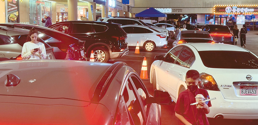 Cars crowd a Koreatown parking lot amid the LA parking war during year-end gatherings